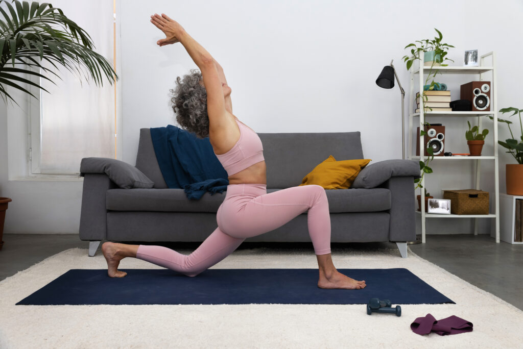 woman doing low lunge stretch yoga exercise at home for weight loss routine in the living room