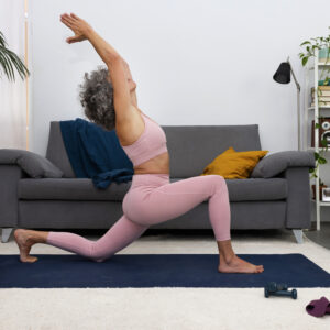 woman doing low lunge stretch yoga exercise at home for weight loss routine in the living room