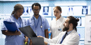 Healthcare professionals discussing patient reports and treatment plans, showcasing real-world opportunities in health careers without a degree